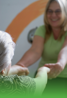 caregiver and elderly woman holding each others hand